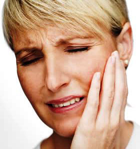 A woman who needs relief from a TMJ dentist.