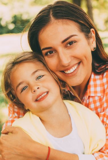 Young mother and gradeschool daughter - for information on pediatric dentistry